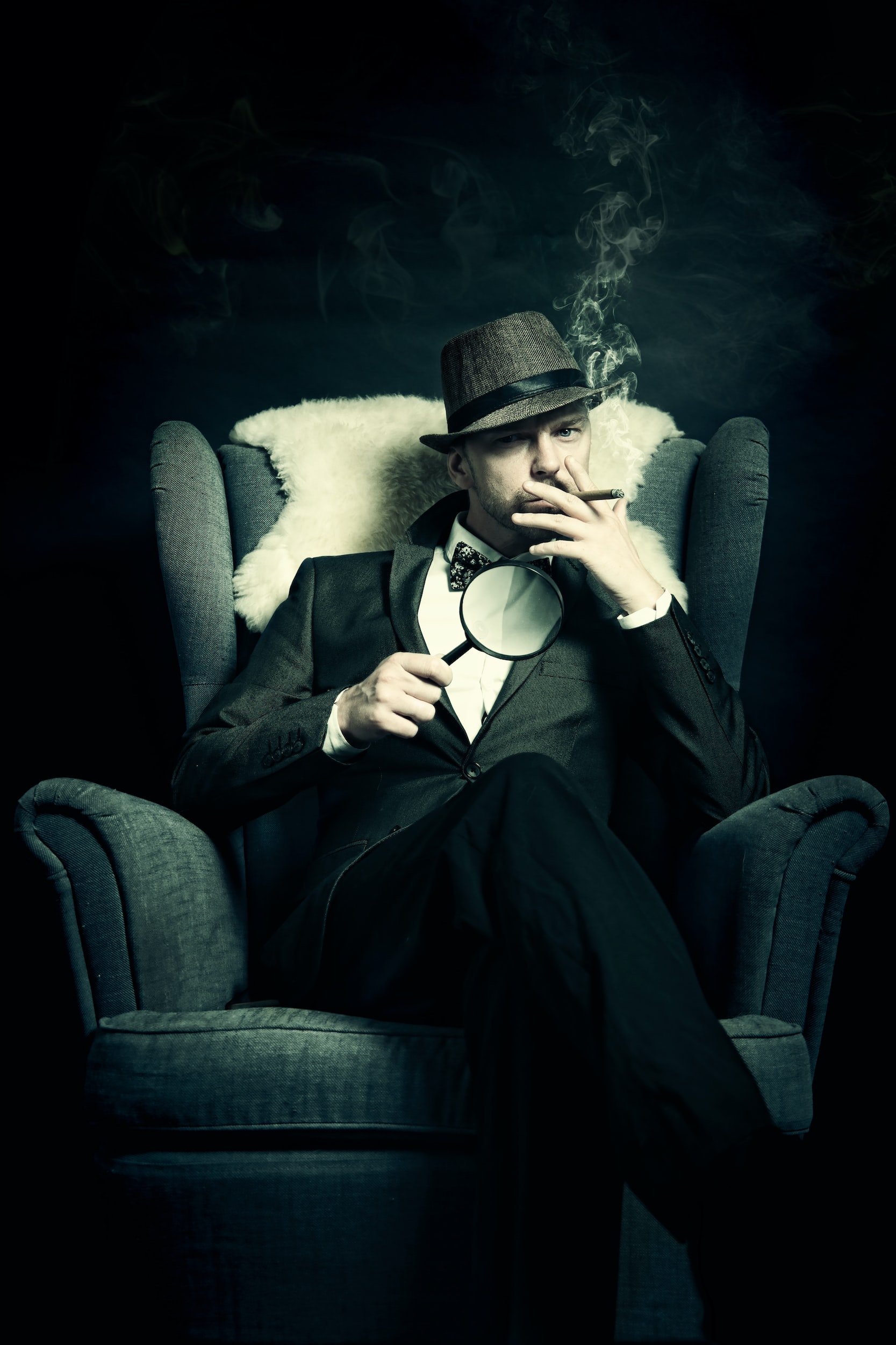 private detective holding a magnifying glass